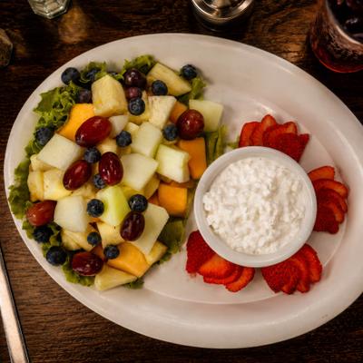 Fresh fruit plate served with cottage cheese and sliced strawberries.