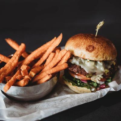 Cheeseburger, with green chili, jalapenos, lettuce, onion, tomato, and sweet potato fries.