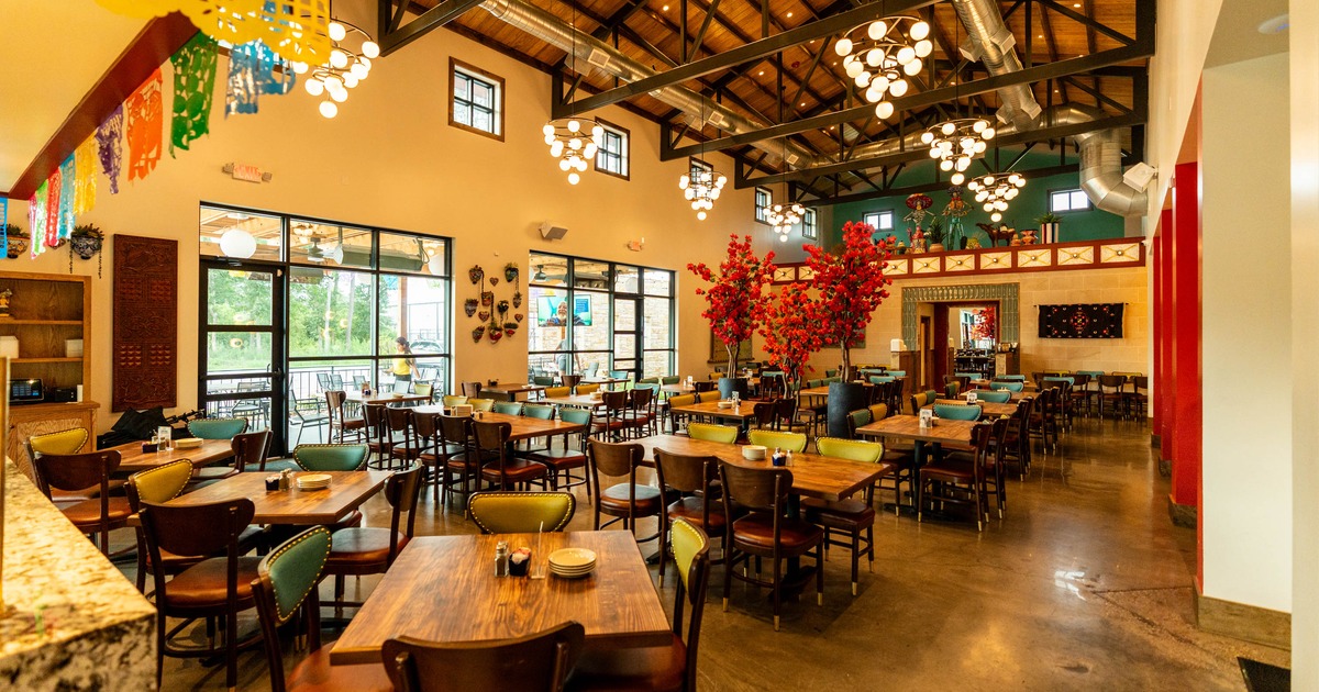 Interior seating area with wooden tables and colorful decorations