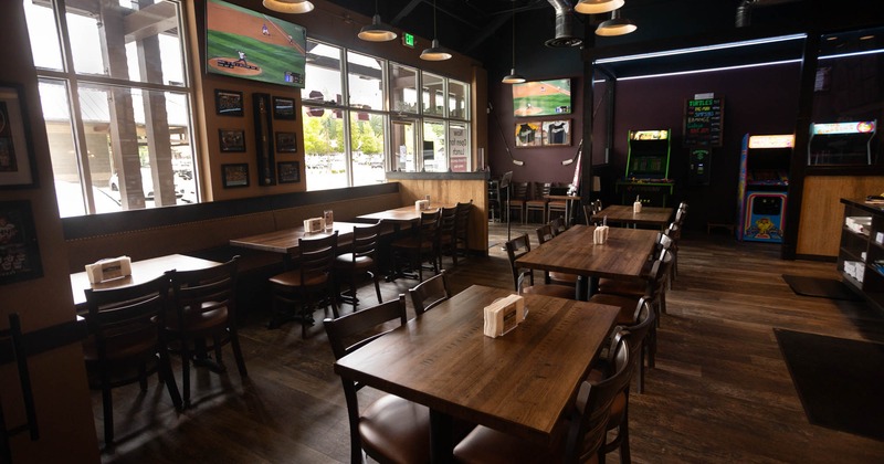 Interior, dining area, wooden top tables with chairs, banquette bench with tables