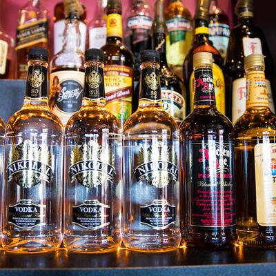 Shelf with bottles of hard drink