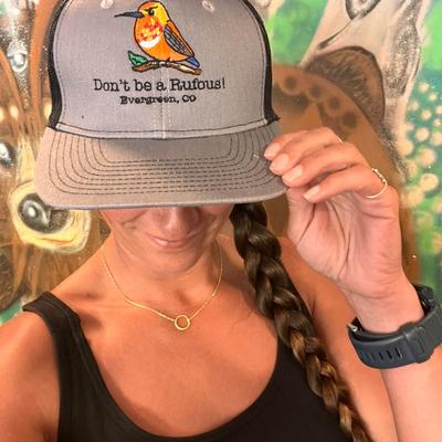 A person potting on the branded hat.