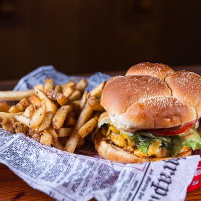 Cheeseburger served with a side of french fries.