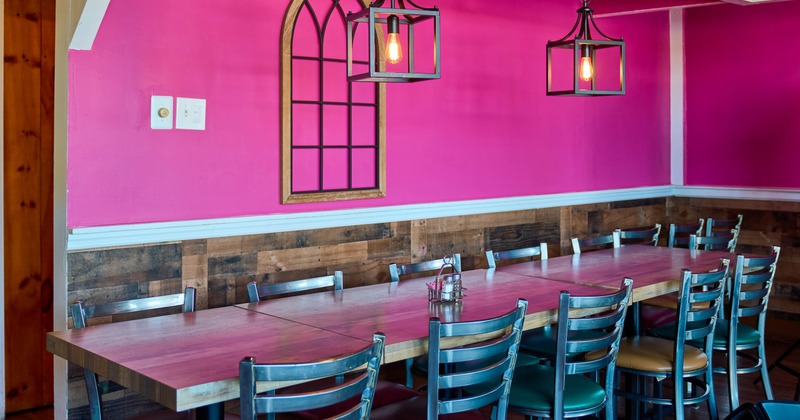 Interior, tables and chairs by the pink wall