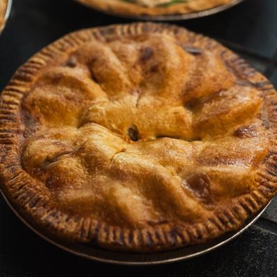 A classic double-crusted apple pie with a golden-brown, flaky top crust.