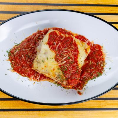 Lasagna Bolognese with mozzarella cheese and tomato sauce, overhead view.