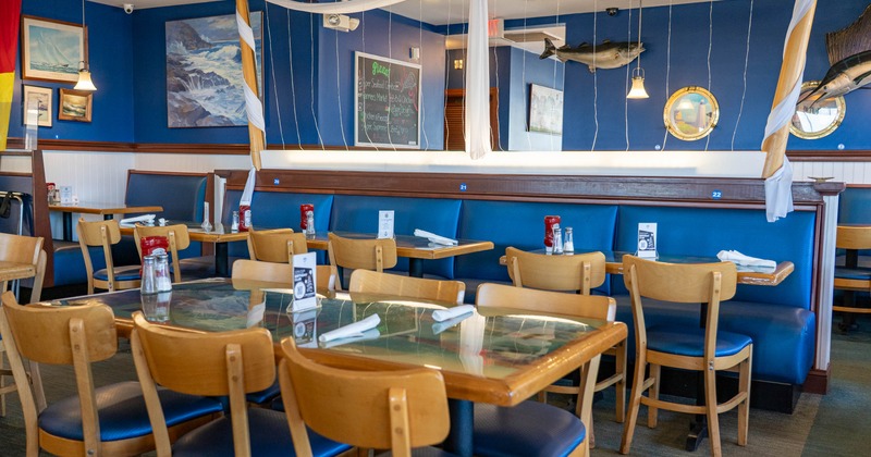 Interior, seating and dining area, padded banquette bench with tables and chairs, regular tables