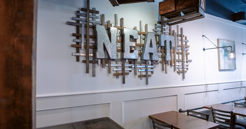 Interior, tables by the wall, sign above