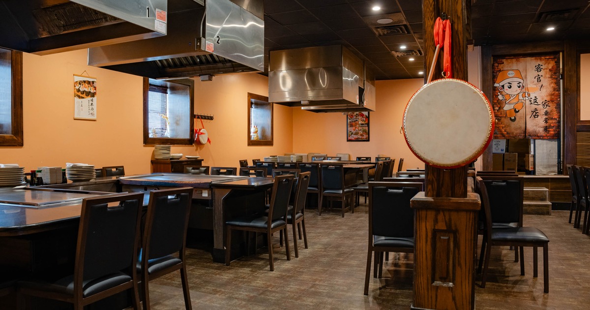 Interior dining area with chairs and hibachi prep tables