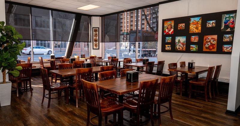 Interior, tables and chairs lined up, by the window