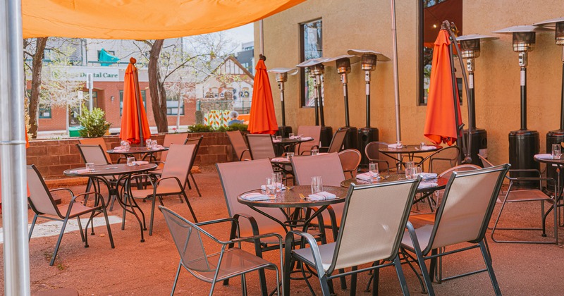 Exterior, patio covered with awning, tables with tableware and seating