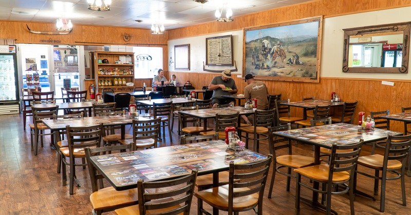Spacious and cozy interior dining area with a few guests enjoying their food