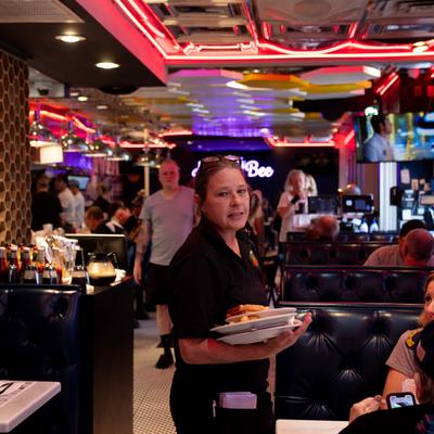 Staff member carrying food.