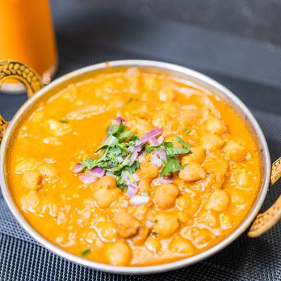 Chana Masala topped with onions and cilantro.