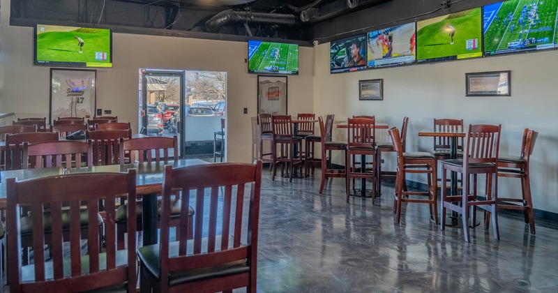 Interior, dining tables and chairs, TVs on the walls