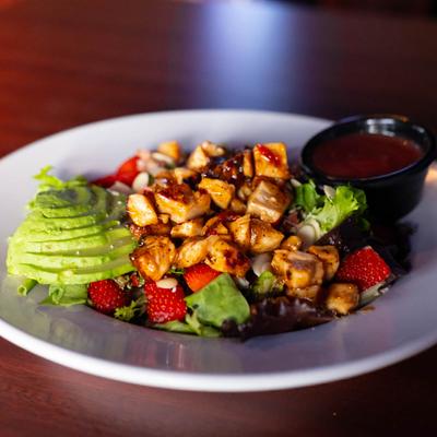 Chicken & Strawberry salad with greens, bacon, bleu cheese, almonds, and avocado.