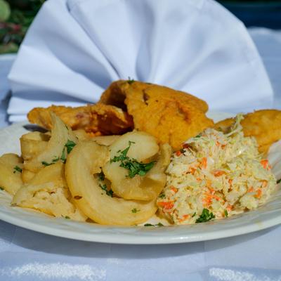 Whiting fillet served with sides of fries and coleslaw.