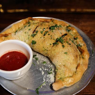Calzone, with marinara sauce.