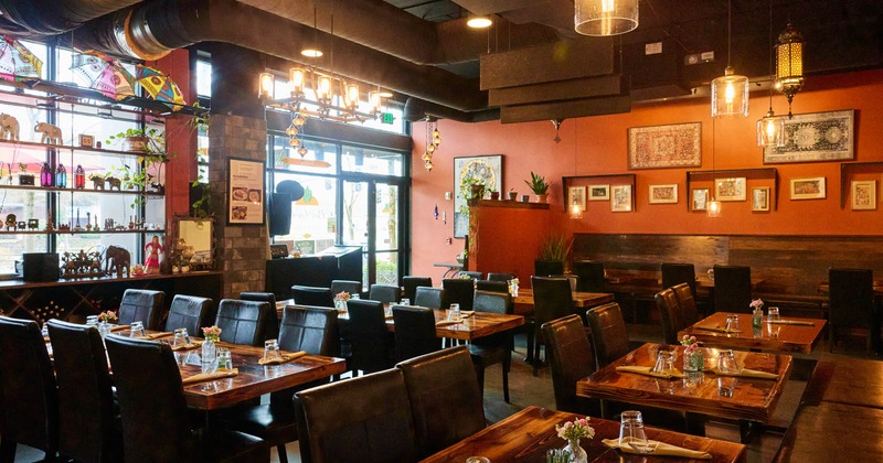 Interior, open space dining area, wooden top tables with chairs, ready for guests