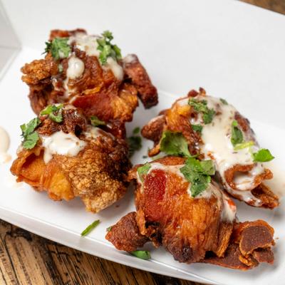 Deep fried pickles covered in spicy ranch sauce.
