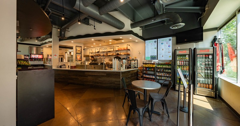 The Lunch Lounge interior, order counter, a table with chairs, fridges, snack racks