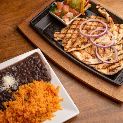 Grilled chicken breasts served with fresh salsa, guacamole, black beans and Mexican rice.