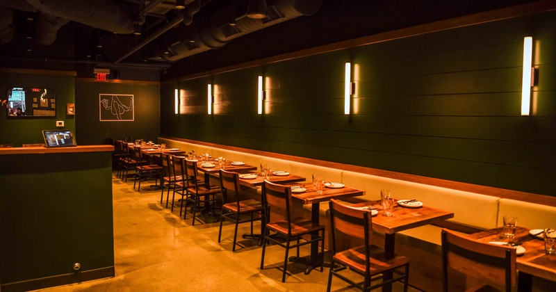 Interior, lined up dining tables with wall seating and chairs