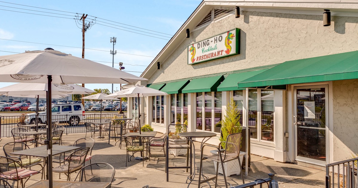 Exterior, patio, partially covered seating area, tables and chairs under parasols