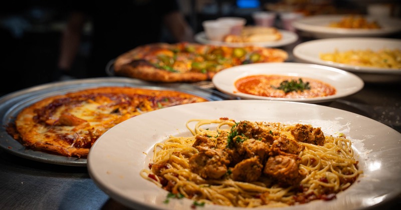 Multiple pasta and pizza plates