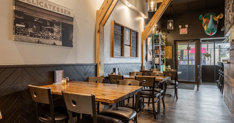 Interior, dining area, tables and chairs ready for guests, menu board on the wall