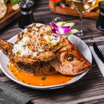 Whole red snapper filled with coconut-pineapple rice and crab meat.