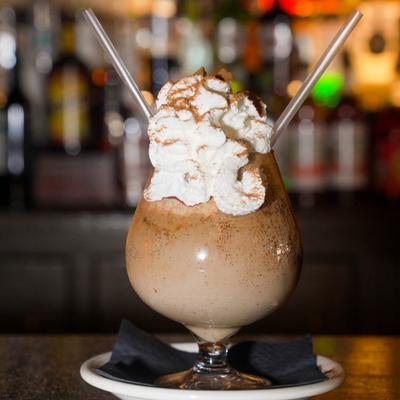 Flaming Mallorca Coffee topped with whipped creama and cocoa powder.