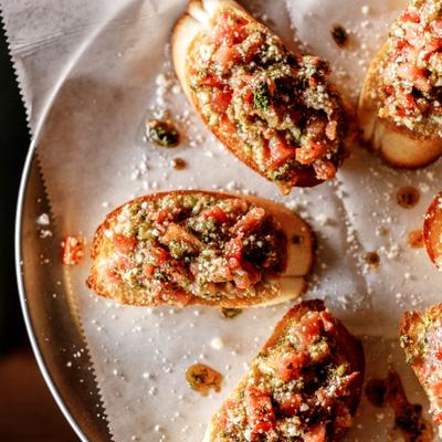 Portion of Bruschetta served on a plate, overhead view.
