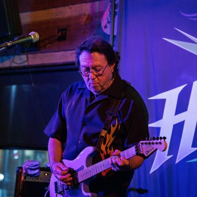 Person playing guitar on the stage.