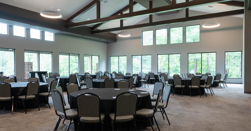 Interior, open space event area, round tables for ten, carpet flooring