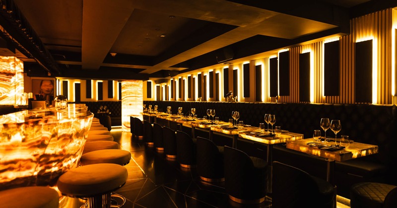 Interior, dining area, long padded banquette bench with tables and chairs