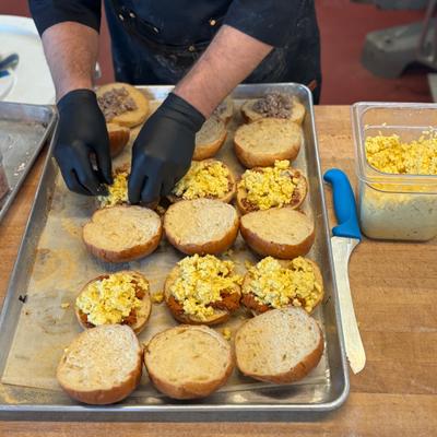 Kalis Bruce making breakfast sandwiches.