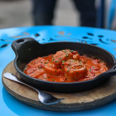 Pan-seared scallops with roasted red peppers, cherry tomatoes, crushed red pepper, vodka sauce