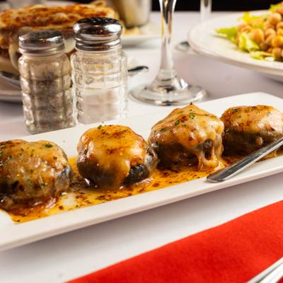 Stuffed mushroom caps covered in melted cheese