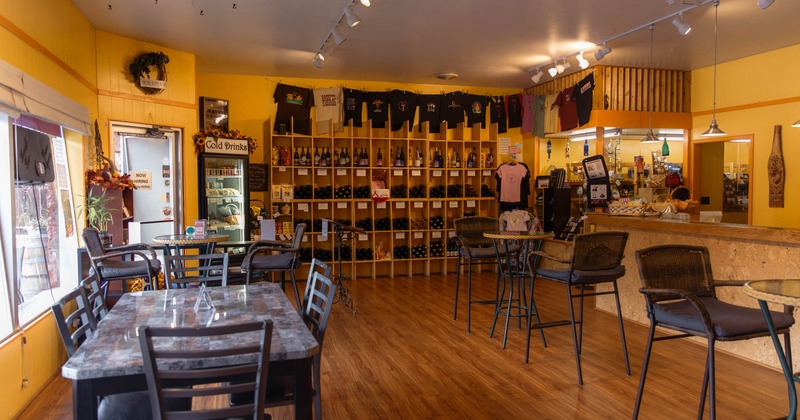 Interior, tables, chairs, bottles on shelves, decorations, windows