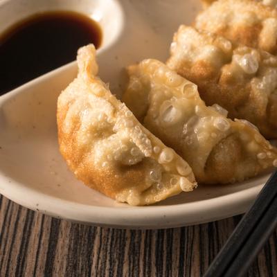 Gyoza plate with a dipping sauce.