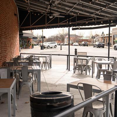 Exterior outdoor seating area cover featuring tables and chairs.