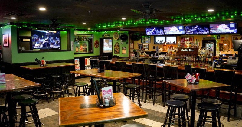 Interior features tables with bar stools and a bar