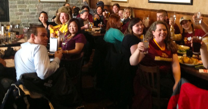 Group of people raising their glasses in a celebratory toast