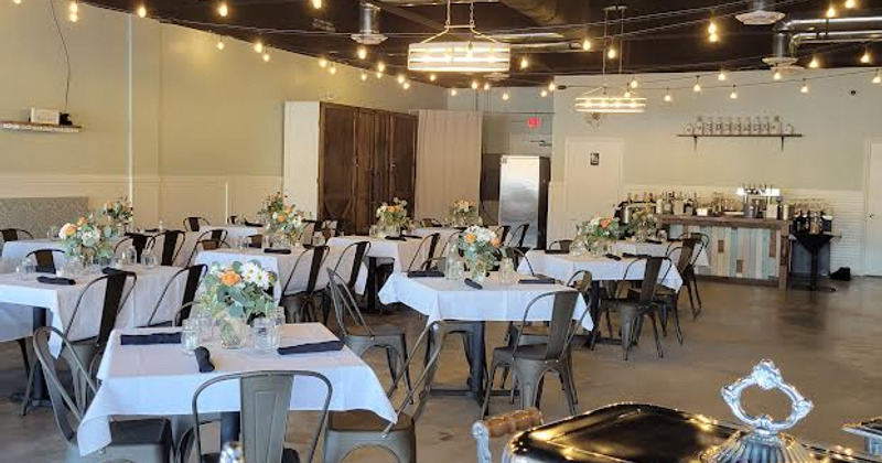 Interior, the bar with wall TVs and guests sitting at tables