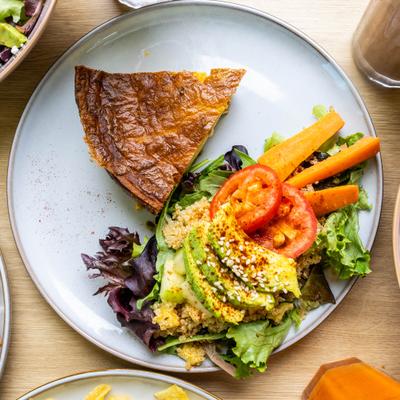Ham, Bacon and Green Chili Quiche served with salad on the side.