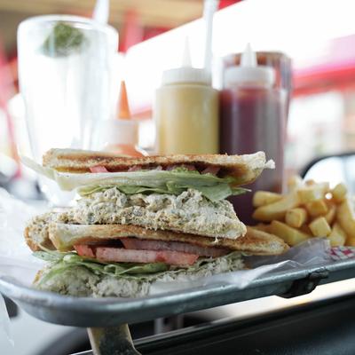 Tuna fish salad sandwich with fries.