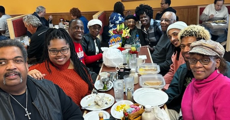 A group of people dining in a busy restaurant