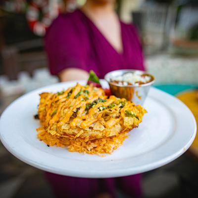 Person holding plate of Jalepeno Maize Chicken.