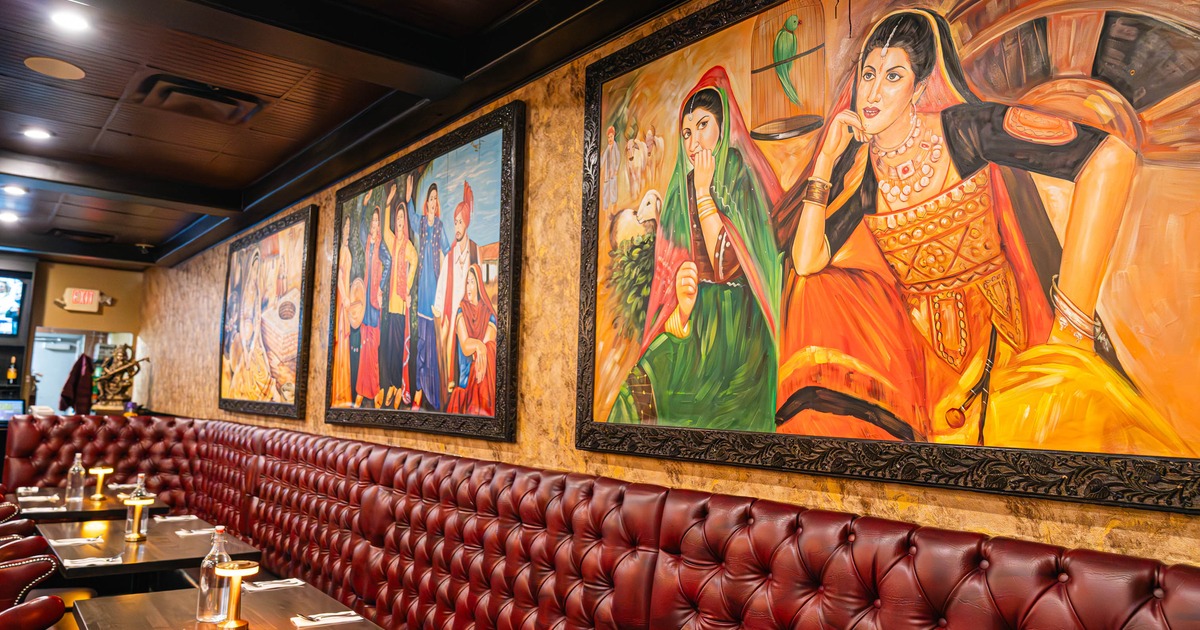 Interior, dining area, large banquette bench with tables and chairs, large format paintings